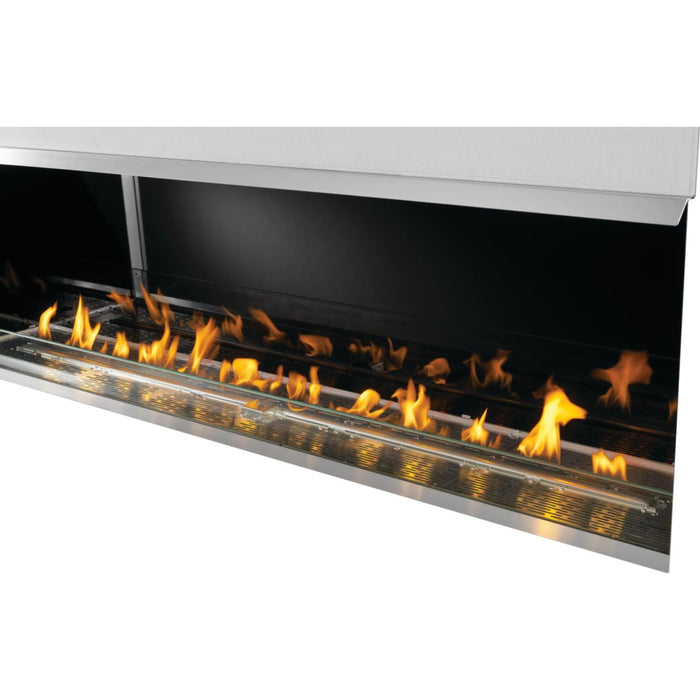 Napoleon Galaxy 74-inch outdoor gas fireplace with blue LED ember bed lighting, glass wind guard, and stainless steel firebox.