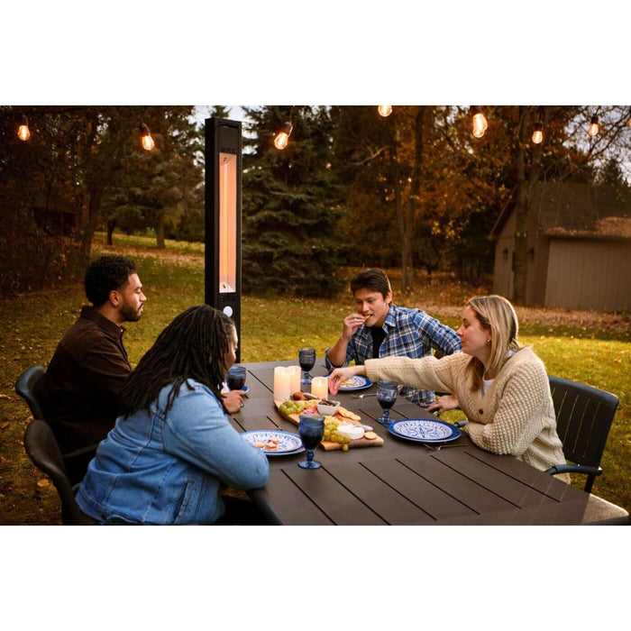 Napoleon Phantom outdoor infrared patio heater providing radiant warmth for four people dining around a backyard patio table