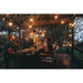 Napoleon Phantom freestanding electric patio heater warming an outdoor dining area with guests seated beneath string lights