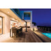 Napoleon Phantom freestanding infrared patio heater positioned beside a modern outdoor dining area and swimming pool