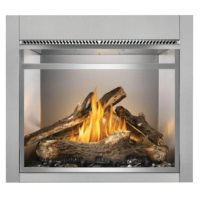 Front view of Napoleon Riverside 36-inch outdoor gas fireplace with oak logs, decorative metal front frame, and stainless steel firebox.