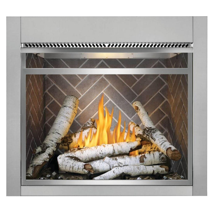 Napoleon Riverside 36-inch outdoor natural gas fireplace with white birch logs, herringbone decorative interior panels, and metal front frame.