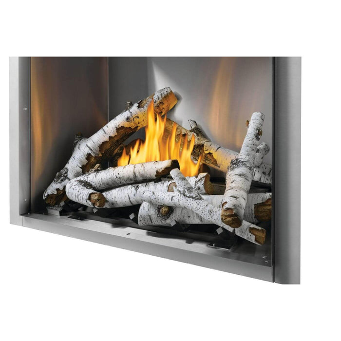 Angled view of Napoleon Riverside 36-inch outdoor natural gas fireplace featuring white birch logs, burning flames, and clean-face design.