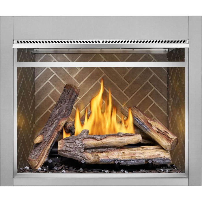 Napoleon Riverside 42 outdoor fireplace featuring oak-style logs, vibrant flames, and decorative herringbone interior panels.