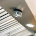 Close-up of Summerset Outdoor Vent Hood control knob and integrated LED lighting beside stainless steel baffle filters