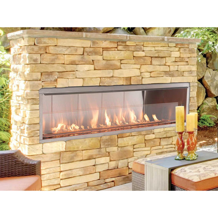 Superior VRE4600 contemporary outdoor vent-free linear gas fireplace installed in a stone patio wall with glass media and flames.