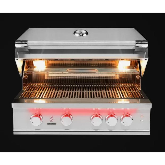 TrueFlame 32-inch built-in gas grill with hood open, illuminated cooking surface, stainless steel grates, warming rack, and LED controls.