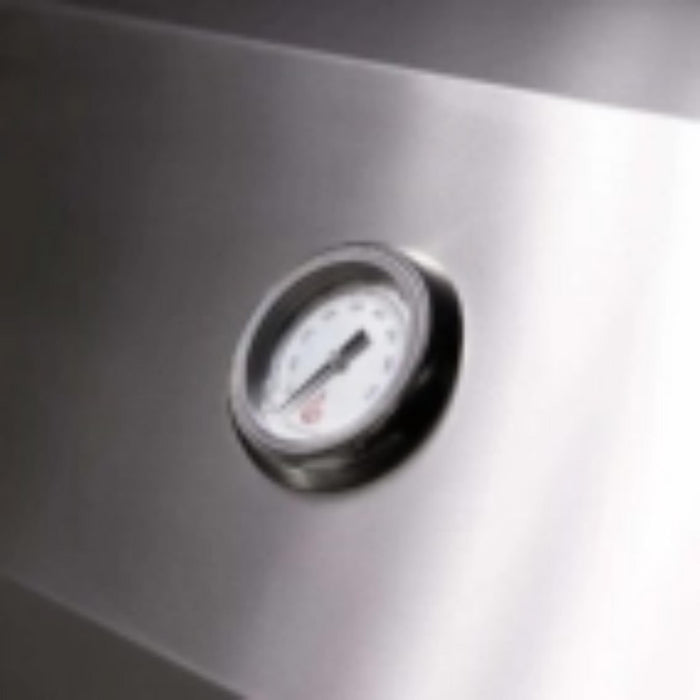 Close-up of temperature gauge integrated into the stainless steel hood of a TrueFlame built-in gas grill.
