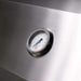 Close-up of temperature gauge integrated into the stainless steel hood of a TrueFlame built-in gas grill.