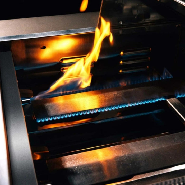 Close-up of TrueFlame built-in gas grill burners and stainless steel flame tamers operating with blue flames.