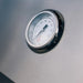 Close-up of the TrueFlame E-Series built-in gas grill hood-mounted analog temperature gauge.
