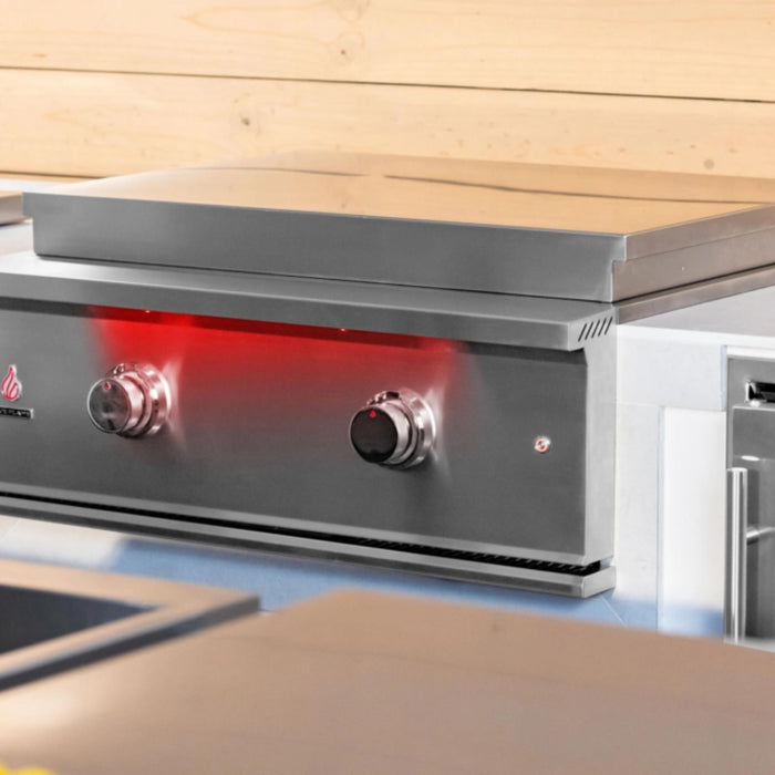 TrueFlame 30-inch built-in gas griddle with stainless steel lid closed in a premium outdoor kitchen installation