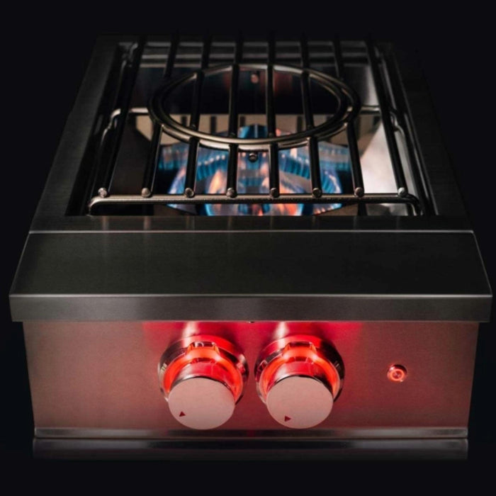 TrueFlame outdoor power burner with dual ring burner, wok grate, and red LED control lighting shown against a dark background.