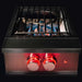 TrueFlame outdoor power burner with dual ring burner, wok grate, and red LED control lighting shown against a dark background.