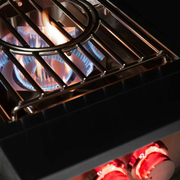 TrueFlame power burner operating with high-output gas flame beneath the removable wok grate and illuminated controls.