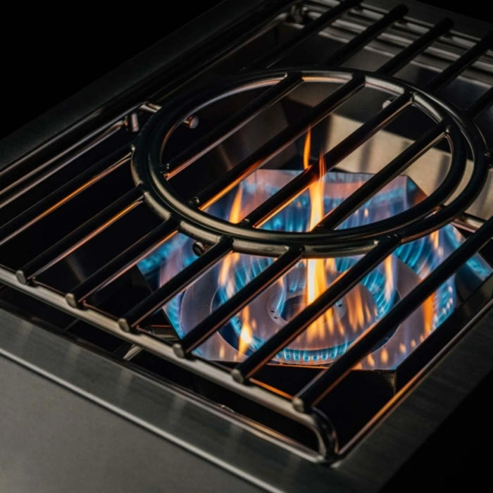 Close-up of TrueFlame power burner dual ring burner flames and removable wok grate for high-heat outdoor cooking.