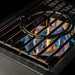 Close-up of TrueFlame power burner dual ring burner flames and removable wok grate for high-heat outdoor cooking.