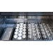 Close-up of Wildfire Ember built-in gas grill cooking surface with infrared sear burner, ceramic briquette heat system, and stainless steel grates