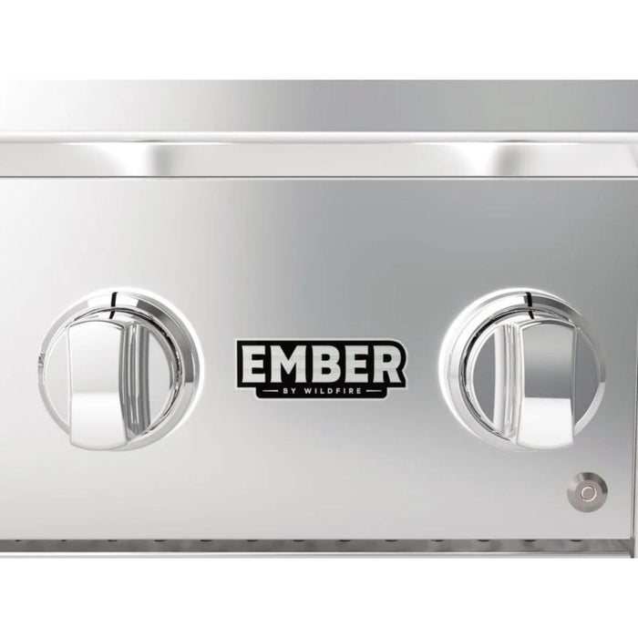 Close-up of Wildfire Ember built-in gas grill control panel with illuminated burner knobs and Ember by Wildfire branding