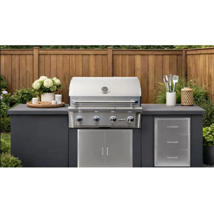 Wildfire Ember 32-inch built-in gas grill installed in a modern outdoor kitchen with stainless steel storage cabinets and drawers